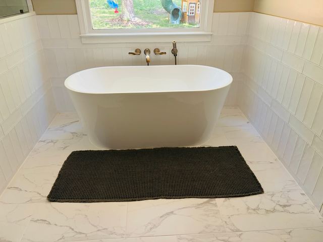 Freestanding tub on a marble-look floor