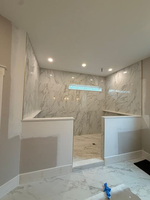 Walk-in marble-look shower with a window