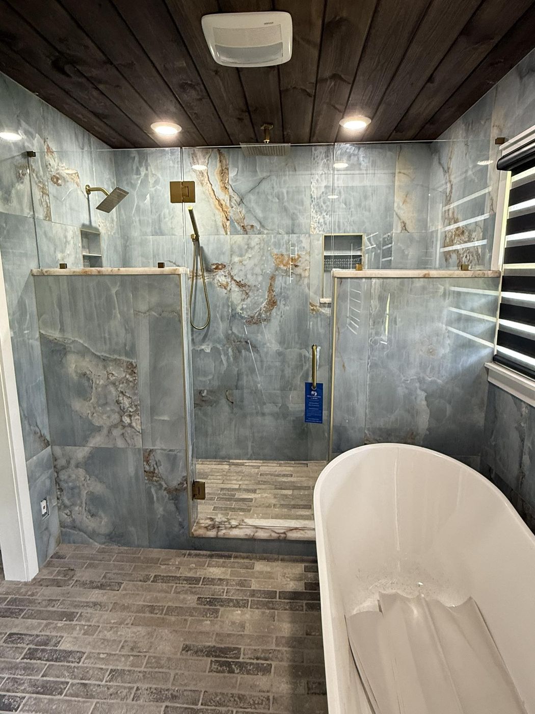 Blue onyx-look wet room with a freestanding tub