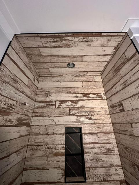 Whitewashed plank-look shower, floor to ceiling